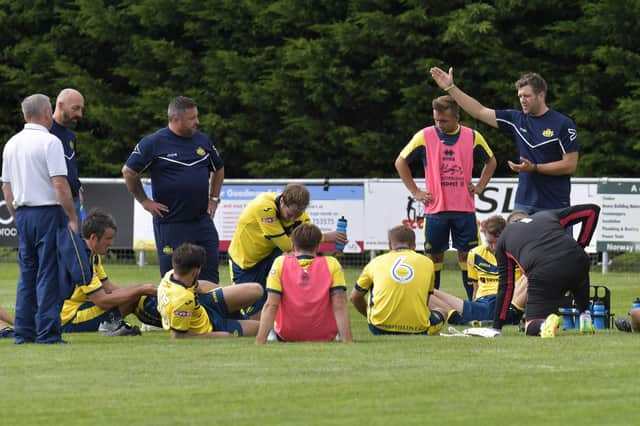 Mat Jones, far right, talks to the Moneyfields players at the end of a game in 2017. Picture: Neil Marshall