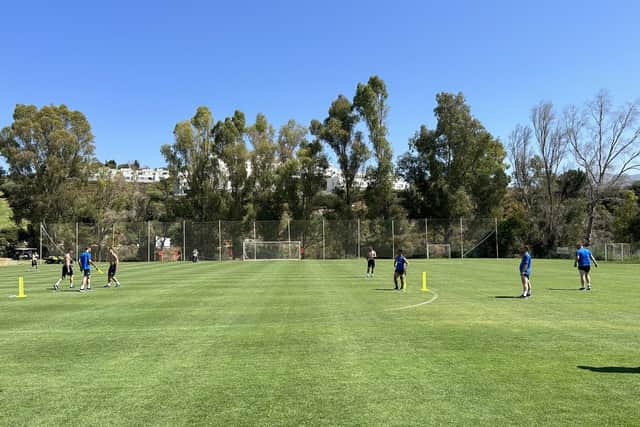 Pompey's staff play cricket after Tuesday's training session at the La Cala Resort.