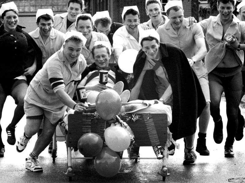 Weapons Engineering Mechanics from HMS Collingwood take charge with a charity bed push from Wykeham day Hospital to Fareham, 1993. The News PP5532