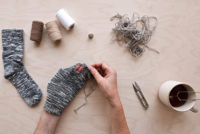 Use down time to mend clothes (photo: Adobe)