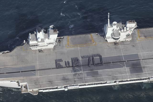 More than 300 Royal Navy sailors spelling out a giant Platinum Jubilee greeting to the Queen on the flight deck of the aircraft carrier HMS Queen Elizabeth. Nearly half the crew of the Navy's flagship stood strong in bracing winds to form the tribute spelling out E II R 70 while off the south coast of England. Issue date: Tuesday May 31, 2022.