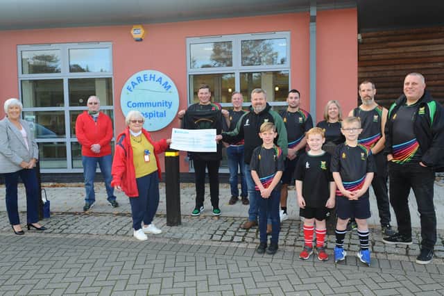 Fareham Community Hospital officials Sue Westcott (trustee and fundraiser, left), Peter Humphreys (treasurer, second lef) and Jill Sadler (trustee and vice chairman, third left)  with Locksheath Pumas RFC officials and players. Picture: Sarah Standing