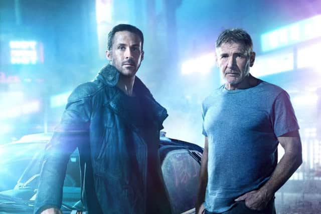 Ryan Gosling, as Agent K, and Harrison Ford, as Rick Deckard.