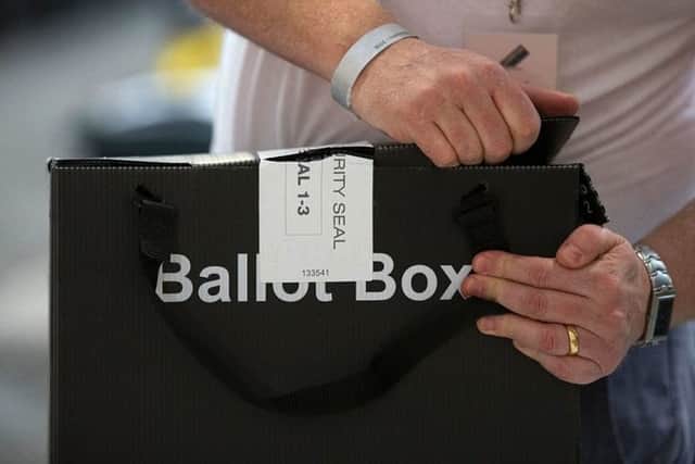 A member of the count staff opens a sealed ballot boxes containing voting slips (Photo: Getty Images)