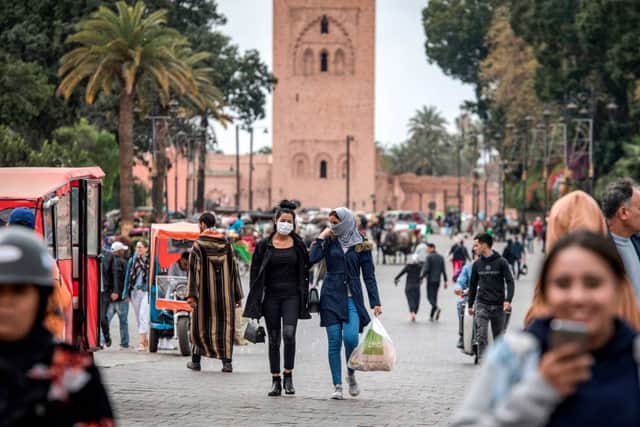 Masked women walk throguh Marrakesh's Jamaa el-Fna square (Getty Images)