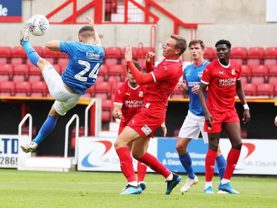 Conor Chaplin acrobatically fires at goal today at Swindon. Picture: Joe Pepler