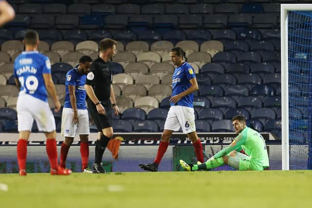 Anton Walkes, left from centre, dejected after scoring an own goal against AFC Wimbledon. Picture: Joe Pepler