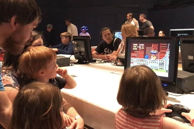 Peter Howell, his son Oscar, and fellow gamers at the festival