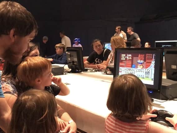 Peter Howell, his son Oscar, and fellow gamers at the festival