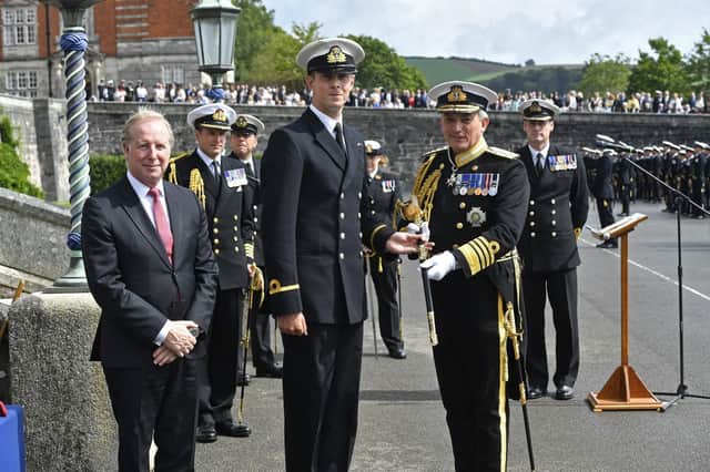 Sub Lieutenant Edward Timpson is presented with the Officers Association Sword by guest of honour Admiral Sir Philip Jones KCB ADC, First Sea Lord, Chief of the Naval Staff.f