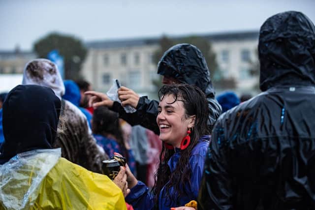 Pouring rain doesn't stop fans at the Common Stage smiling. Picture: Vernon Nash
