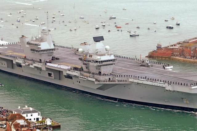Fancy this picture on your favourite mug? HMS Queen Elizabeth entering Portsmouth Harbour.