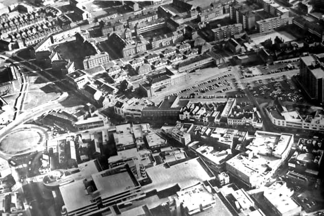 The various styles of architecture found in the heart of Portsmouth in 1970. In the foreground is the Tricorn and behind it the diverse styling of the shops and stores in Commercial Road. The gabled roofs of the Victorian houses left, can be contrasted with the sloping roofs of the blocks of flats, centre.