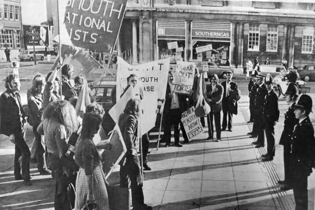 A handful of demonstrators await the arrival of the prime minister at Portsmouth Guildhall.