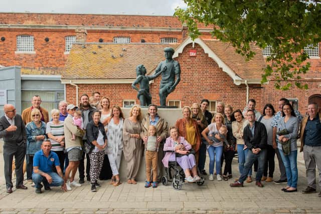 Alexander Baldacchino in front of the Mudlarks' Memorial, centre, surrounded by his family and friends. Picture: Polly Richards