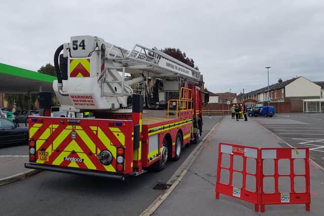 Police and firefighters have cordoned off Asda car park in Fratton after reports of man on three-storey building nearby. Picture: Habibur Rahman