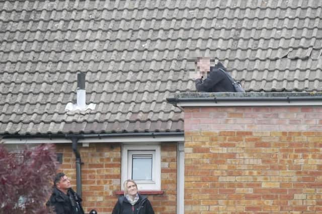 Police speaking to the man on the roof. Picture: Habibur Rahman