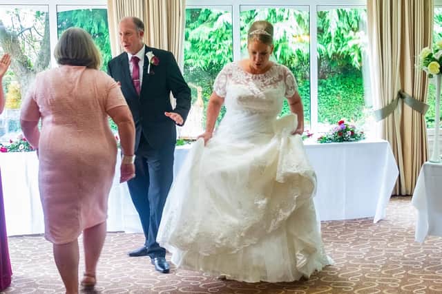 The newlyweds were joined by guests to jump over the broom.