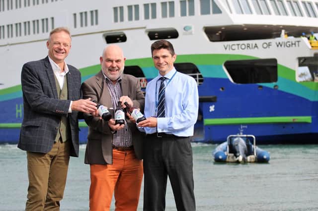 Chris Mousley from Island Brewery, John Nicholson from CAMRA and Wightlinks Simon Lewis with Victoria of Wight Ale and the ferry in the background. Picture: Wightlink