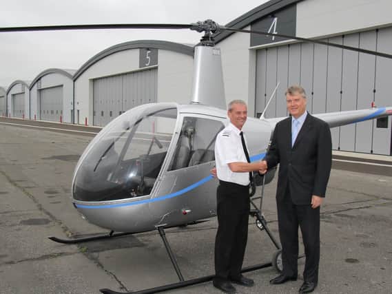 Fareham Borough Council leader Cllr Sen Woodward (right) with Paul Andrews, managing director of Phoenix Helicopters, at Solent Airport at Daedalus.