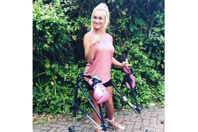 Kate Farley with her walker - and signature pink boxing gloves. Picture: Great South Run