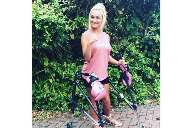Kate Farley with her walker - and signature pink boxing gloves. Picture: Great South Run