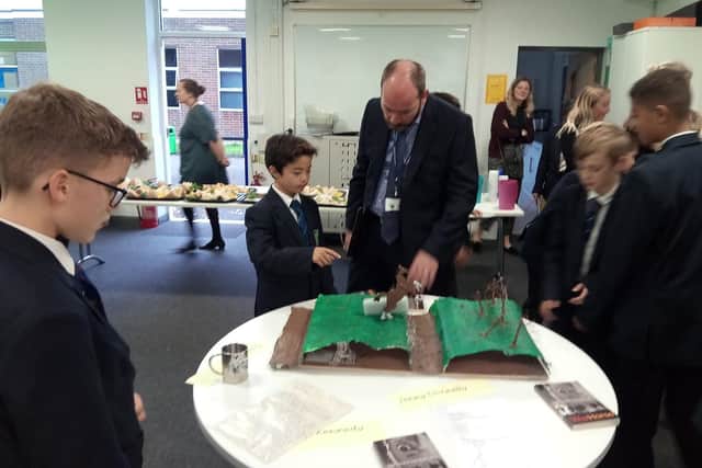 Headteacher Simon Harrison looking at examples of students' work