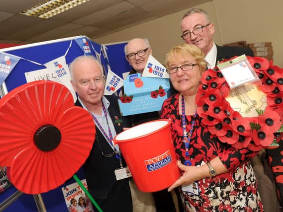 Philip Pyke, deputy organiser for the Portsmouth Poppy Appeal, Kenneth Slater, Portmouth Poppy Appeal volunteer and member of the Royal British Legion at Portsmouth South branch, Louise Purcell, organiser of the Portsmouth Poppy Appeal and Chris Purcell, president of the Royal British Legion at Portsmouth South branch, at the shop in Fratton. Picture: Sarah Standing