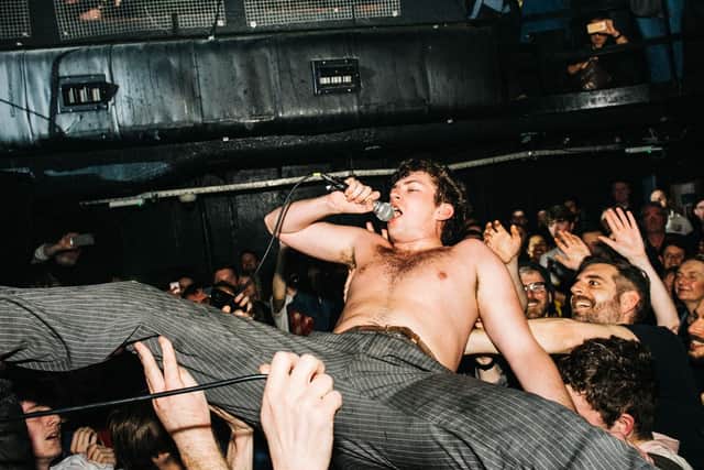 Charlie Steen of Shame goes crowdsurfing. Picture by Jordan Hughes
