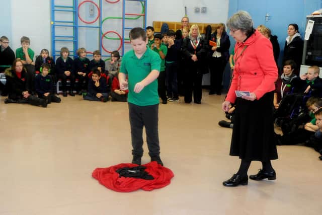 Harper-James King, 10, and the Rev Susan Allman from St Peter's Church in Titchfield, during the Remembrance assembly.
Picture: Sarah Standing (180819-9325)