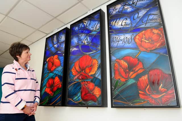 Mary Knapman, a committee member with the Gosport War Memorial League of Friends, admiring the stained glass panels Picture: Sarah Standing (180821-9450)