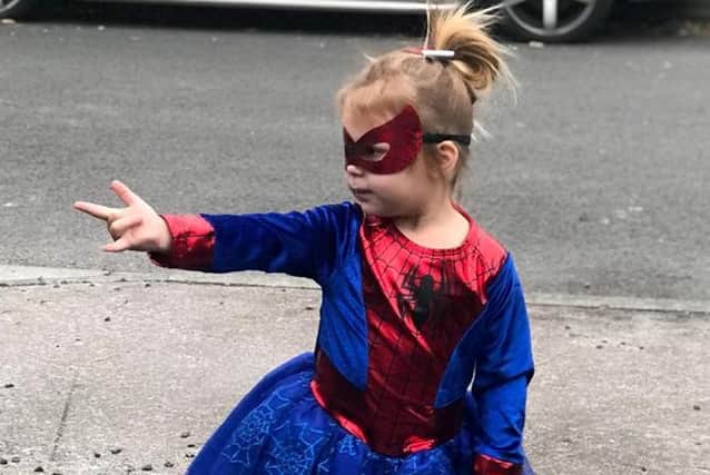 Darcy Raine Cheshire in her favourite Spiderman outfit. Picture: Aaron Cheshire / SWNS.com