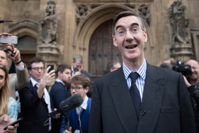 Jacon Rees-Mogg smiling after a press briefing in Westminster  Photo: PA