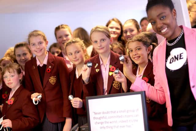 From left, Genevieve Newman, 10, Imogen Wallace, 10, Jemima Holden, 13, Isabelle Gabriel, 10, Erin Liu, 10, and Temilola Adeleye (One Campaign) display One Campaign badges in support of the fight against poverty
