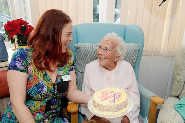 Leoh Howlett, activities co-ordinator at Southlands Nursing Home, sings 'Happy Birthday' to Gladys Winkworth. Picture: Sarah Standing (180829-68)