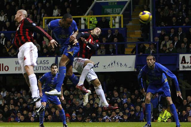 Younes Kaboul heads Pompey into the lead against AC Milan, with Richard Hughes in the background
