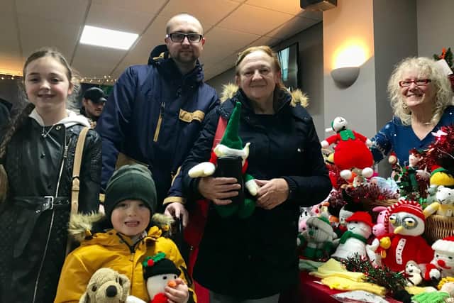 Angel Castledine, 11, Reuben Castledine, five, Adam Castledine, 32, Caryl Castledine, 64 and trader Janet Ross, 62 at the Love Baffins Christmas market
