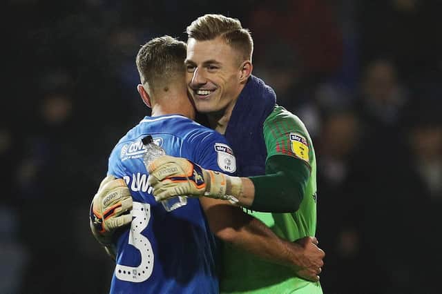 Craig MacGillivray celebrates Pompey's win over Walsall with Lee Brown. Picture: Joe Pepler