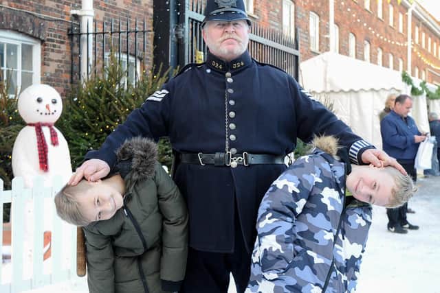Double trouble: Twins Olo and Czarek 10 with Alan Myatt, policeman and town crier. Picture: Habibur Rahman