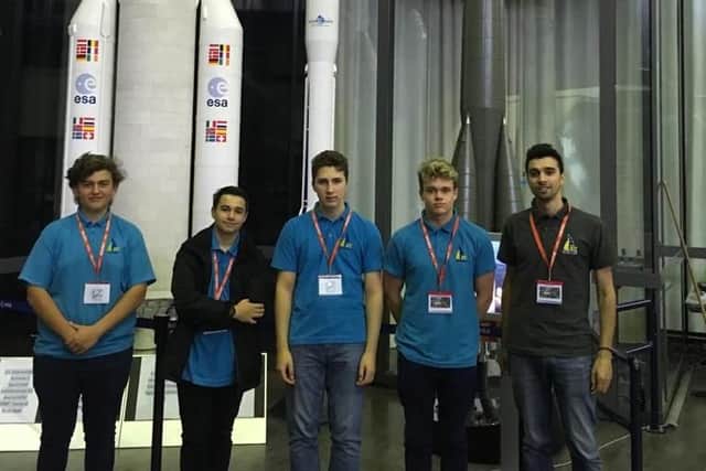 Students Dewald Roos, 15, Ethan Wilson, 15, Andrei Mosora, 16, and Elliot Gilkes Strong, 15, alongside teacher Damien Edmondson at the European Space Technology and Research Centre.