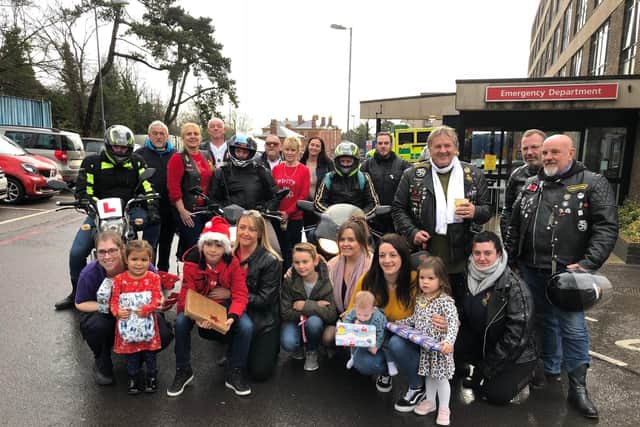 Gosport bikers with just a few of the presents they bought, staff, and their children outside QA Hospital in Cosham