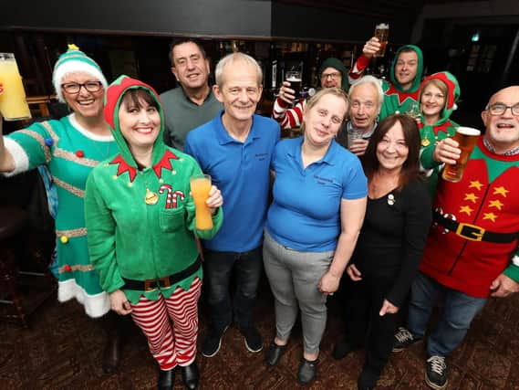 Regulars give landlord and landlady Martin and Diane Munns (both in blue) a send off after seven years at The Fareham pub, Trinity Street, Fareham                         Picture: Chris Moorhouse