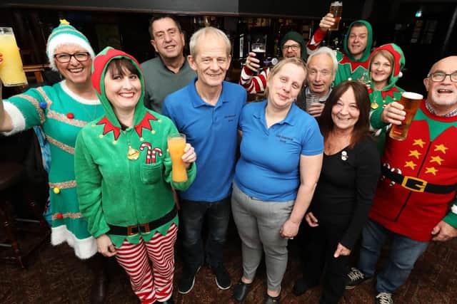 Regulars give landlord and landlady Martin and Diane Munns (both in blue) a send off after seven years at The Fareham pub, Trinity Street, Fareham Picture: Chris Moorhouse