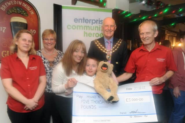 One of Martin's highlights - The Fareham pub in Trinity Street, Fareham, presented Harland Bray and his family a cheque for 5,000 to help buy an assistance dog for Harland who has autism.
Pictured is: (l-r) Landlady Diane Munns, Mayoress of Fareham Anne Ford, Vickie Bray, Harland Bray, the Mayor of Fareham Mike Ford and landlord Martin Munns.
Picture: Sarah Standing (151932-2821)