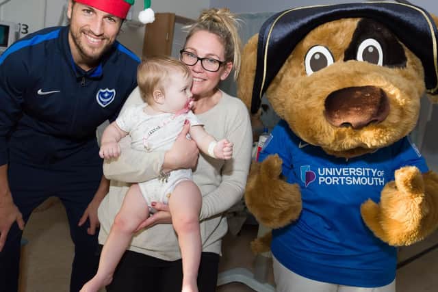 Christian Burgess and the club mascot with Rennai MacGill (8 months) and her mother Toni. Picture: Duncan Shepherd