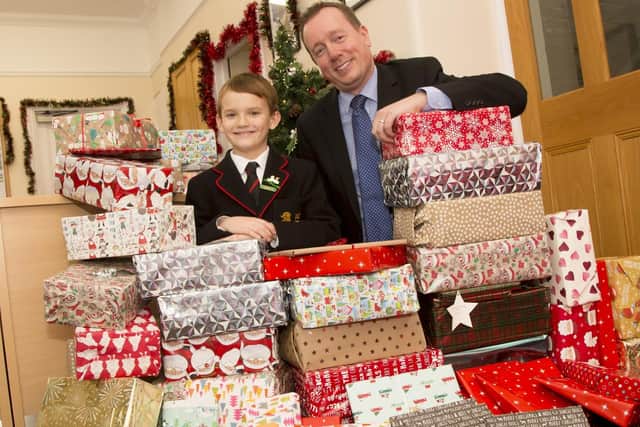 Deputy head teacher Jason Ashcroft, alongside George Tickner and some of his Christmas gift parcels