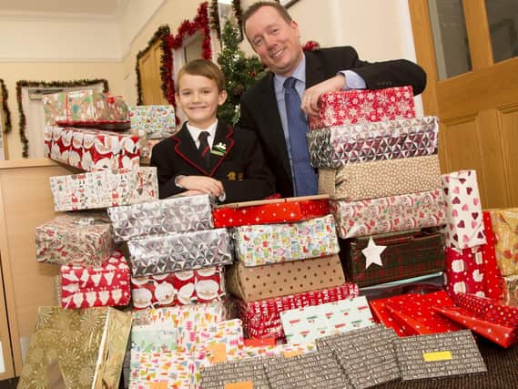 Deputy head teacher Jason Ashcroft, alongside George Tickner and some of his Christmas gift parcels