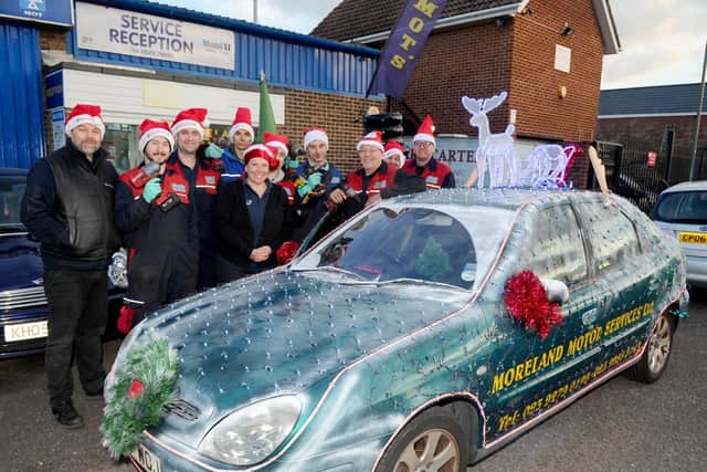 Moreland Motor Services has turned an old courtesy car in a Christmas haven with lights and music.
Picture: Sarah Standing (180881-4071)