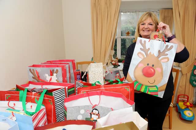 Ellie with her Christmas care packages. Picture: Sarah Standing (180877-3943)