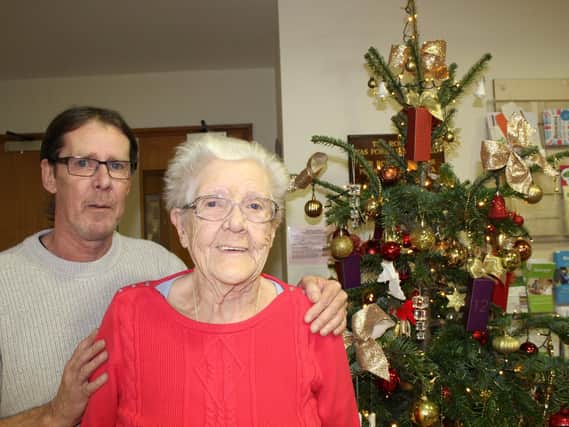 Gordon White and his mum Phyllis, pictured next to the Christmas treeand decorations that their donations havepaid for since 2016